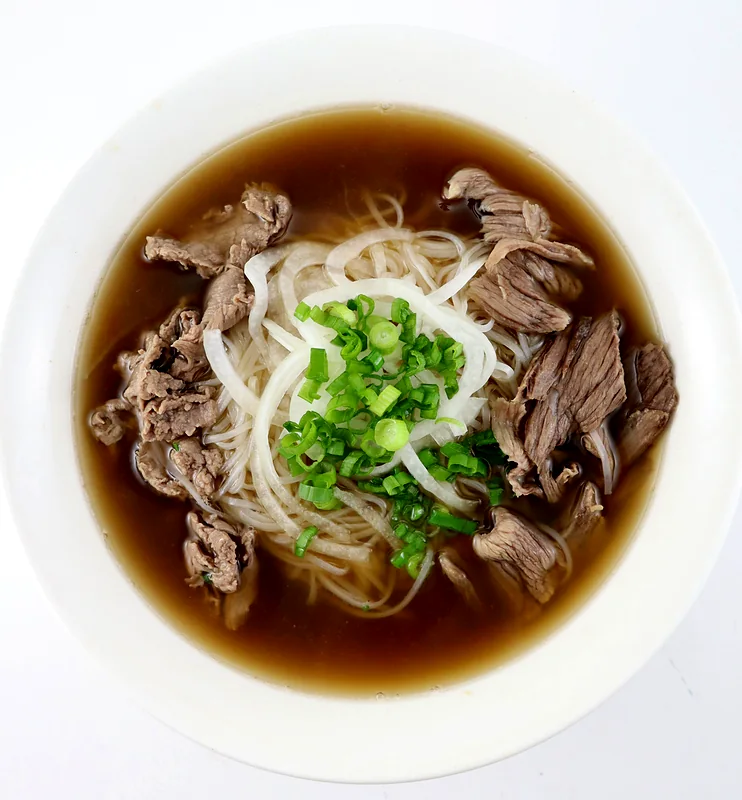 Bowl of beef pho with steak and brisket