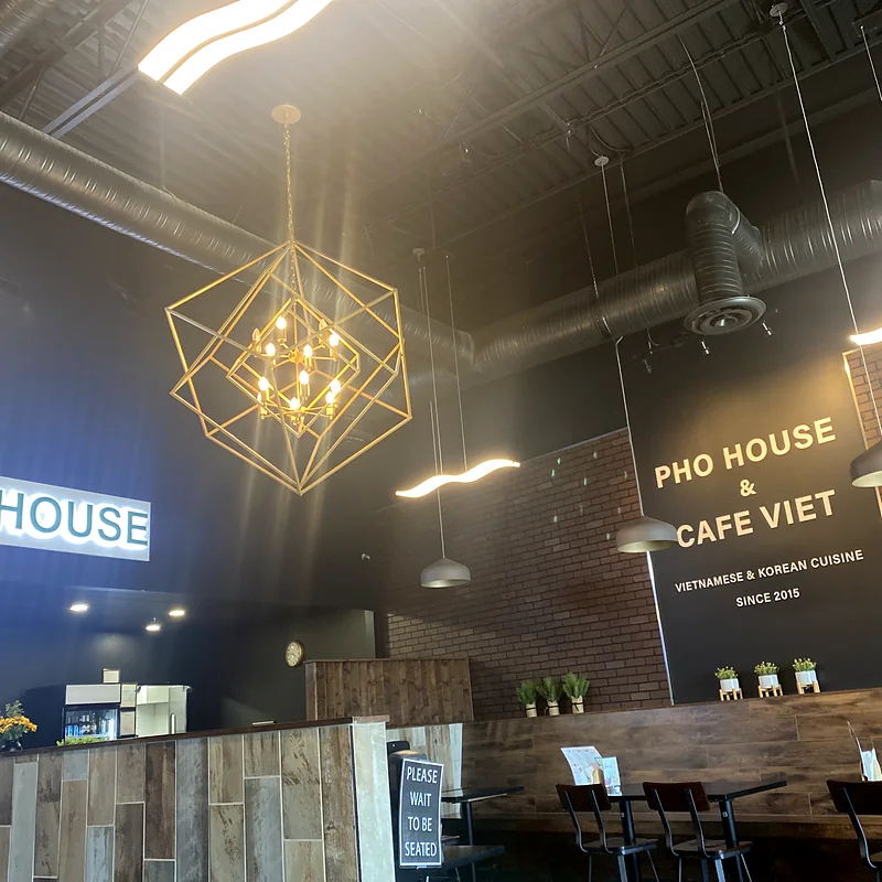 Dining room with the Pho House and Cafe Viet signs
